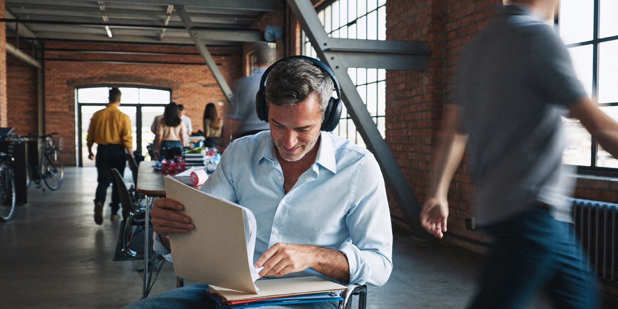 A COO holding one block of focused work in the middle of a busy co-working floor
