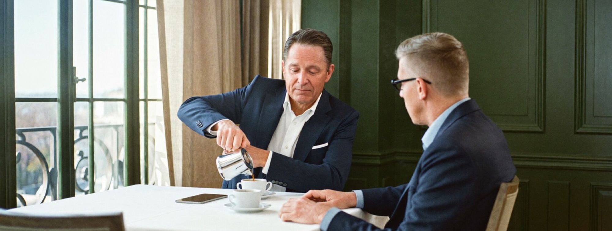 Two business owners over coffee after lunch, comparing notes on margins