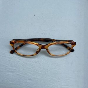 A folded pair of reading glasses, set down at the end of the working day